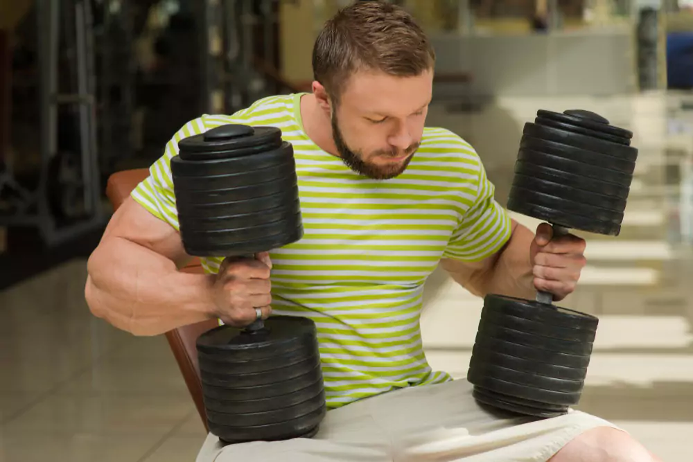 Person performing grip strength test with dumbbells for health assessment.