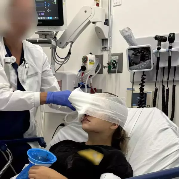 Teen injured in a low-speed car crash suffering from a traumatic eye injury, awaiting recovery.